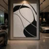 Modern black and cream abstract canvas wall art featuring flowing organic forms in a contemporary minimalist design.
