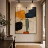 Square Mid-Century abstract canvas wall art featuring olive green, terracotta, charcoal, and cream geometric shapes with a contemporary minimalist composition.