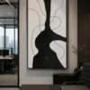 Modern black and cream abstract canvas wall art featuring a bold sculptural silhouette with flowing contour lines.