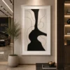 Modern black and cream abstract canvas wall art featuring a bold sculptural silhouette with flowing contour lines.