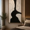 Modern black and cream abstract canvas wall art featuring a bold sculptural silhouette with flowing contour lines.