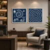 Luxury Warli diptych canvas wall art featuring traditional village life, spiral Tarpa dance motifs, white tribal illustrations, and a deep indigo navy background with black gallery frames.