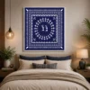 Luxury Warli tribal canvas wall art featuring a spiral Tarpa dance, geometric tribal borders, and white folk illustrations on a deep indigo blue background.