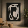 Modern black and cream abstract canvas wall art featuring layered organic rings with sculptural contemporary design.