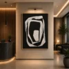 Modern black and cream abstract canvas wall art featuring layered organic rings with sculptural contemporary design.