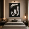 Modern black and cream abstract canvas wall art featuring layered organic rings with sculptural contemporary design.
